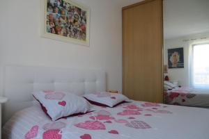 een slaapkamer met een bed met roze harten erop bij COSTEBELLE Appartement entier in Hyères