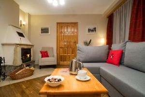 a living room with a couch and a coffee table at Apartamenty ApartArt Zakopane in Zakopane