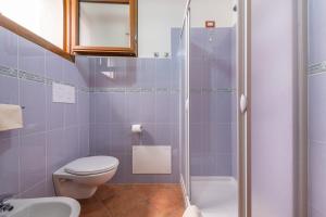 a bathroom with a toilet and a shower at Casa Mediterraneo in Cala Gonone