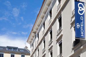 a building with a sign on the side of it at Hotel D Geneva in Geneva