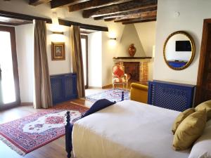 a bedroom with a bed and a fireplace at Palacio de Monjaraz in Avila