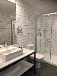 a bathroom with a sink and a toilet and a shower at Gran Hotel Flamingo-Adults Only older 18 years old in Lloret de Mar
