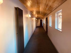 a hallway with a wooden ceiling and a long corridor at The Bannville Hotel in Banbridge