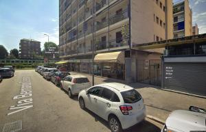 a row of cars parked on the side of a street at Milky House Milan in Milan