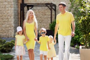 a family walking down a sidewalk holding hands at Alean Family Resort & SPA Doville 5* Ultra All Inclusive in Anapa