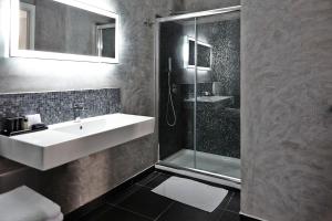 a bathroom with a sink and a shower at La Suite Boutique Hotel in Procida