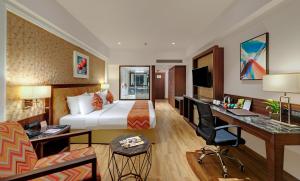 a hotel room with a bed and a desk at The Fern Residency, Satara Maharashtra in Satara