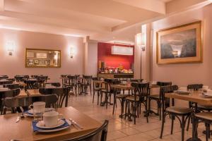 a dining room with wooden tables and chairs at Paris France Hotel in Paris +23 photos