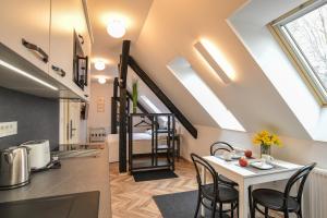 a kitchen and dining room with a table and chairs at Vila Selena in Ljubljana