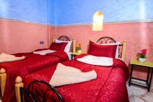 Cama o camas de una habitación en Hôtel Faouzi
