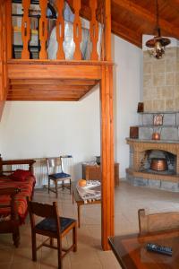 a living room with a couch and a fireplace at Villa Internity in Alikampos