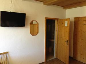 a room with a flat screen tv on the wall at Gasthaus Sonne in Tarrenz