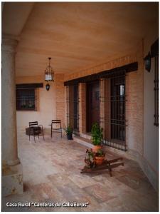 un patio con mesa y sillas en un edificio en Casa Rural Las Canteras de Cabañeros, en Retuerta de Bullaque