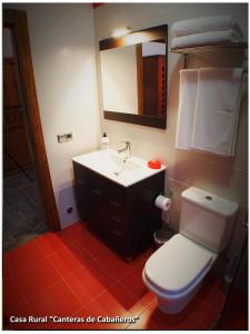 a bathroom with a white toilet and a sink at Casa Rural Las Canteras de Cabañeros in Retuerta de Bullaque