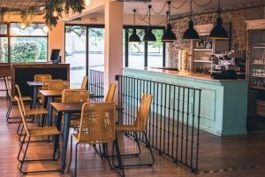 a restaurant with tables and chairs and a bar at Latas Surf Lodge in Loredo +28 photos
