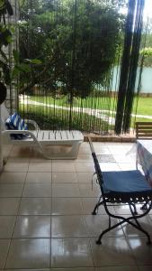 a chair sitting in a room with a tub at Villa Verde Apartments and Rooms in Premantura