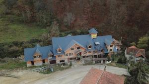 an aerial view of a large house with a blue roof at Golema Reka in Crni Vrh