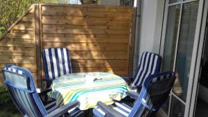 a table and four chairs on a patio at Ferienwohnung Sonneneck Poel in Timmendorf