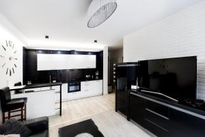 a living room filled with furniture and a tv at Luxury Apartments in Kielce