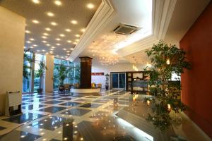 a lobby with a tiled floor with lights on it at Hotel Montenegro in Budva