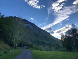 a winding road in front of a mountain at Hotel Adler in Menaggio