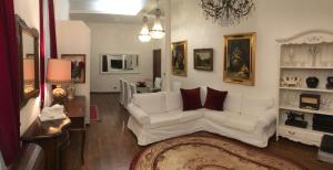 a living room with a white couch and a rug at Colosseo Room in Rome
