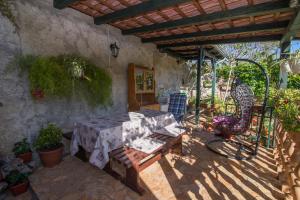 a patio with a table and chairs in a house at Cvita A2+1 in Veli Lošinj