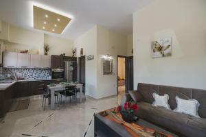 a living room with a couch and a kitchen at Spacious Home with Parking in Chania