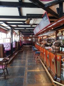 a bar in a restaurant with tables and chairs at Hotel Bishops Arms Köping in Köping +27 photos