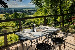 a blue table with chairs and glasses on a balcony at Castello di Buttrio in Buttrio