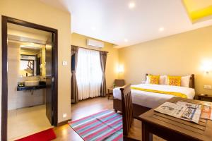 Letto o letti in una camera di Hotel Mala Pokhara