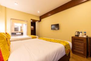 Letto o letti in una camera di Hotel Mala Pokhara