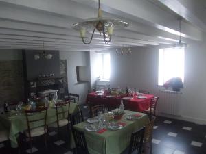 Ca' Do Diao في Onzo: غرفة طعام مع طاولات وكراسي مع مفارش خضراء