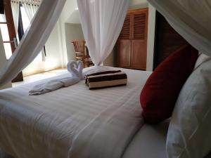 Ein Bett oder Betten in einem Zimmer der Unterkunft Villa di Amed