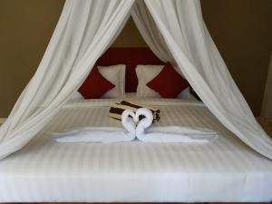 Ein Bett oder Betten in einem Zimmer der Unterkunft Villa di Amed