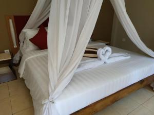 Ein Bett oder Betten in einem Zimmer der Unterkunft Villa di Amed