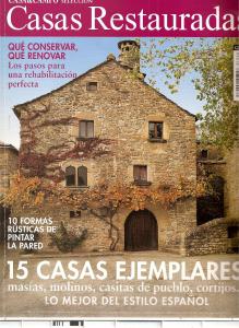 una portada de revista de una vieja casa de piedra en CASA-ABADÍA DE BANAGUÁS, en Banaguás