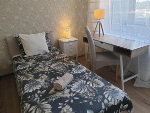 a bedroom with a desk and a bed with a bedspread sidx sidx sidx sidx at Ventspils Seaside Lux Apartments in Ventspils +47 photos