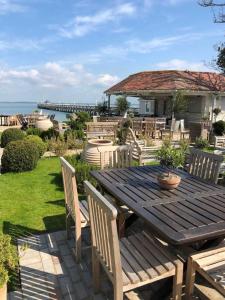a patio with a wooden table and chairs at The George Hotel and Beach Club in Yarmouth
