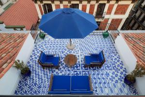 a blue umbrella sitting on top of a white table at Only YOU Boutique Hotel Madrid in Madrid