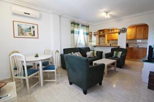 a living room with a couch and a table and chairs at Veramar 6 in Vera