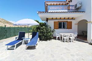 a patio with a table and chairs and an umbrella at Veramar 6 in Vera