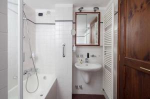 a white bathroom with a sink and a shower at Orizzonte sul mare in Monterosso al Mare