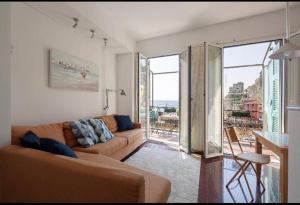 a living room with a couch and a large window at Orizzonte sul mare in Monterosso al Mare +29 photos