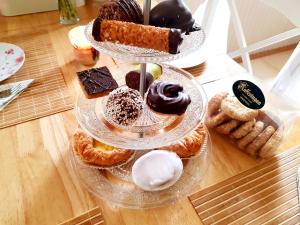 a display of different types of donuts and pastries on a table at Schwedenhaus Lillkvist in Uddeholm +38 photos