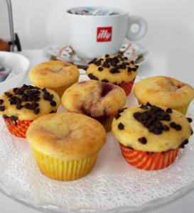 a plate of cupcakes and muffins on a table at ARIA Design B&B Levanto in Levanto