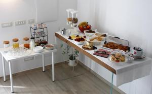 a breakfast table with a bunch of food on it at ARIA Design B&B Levanto in Levanto