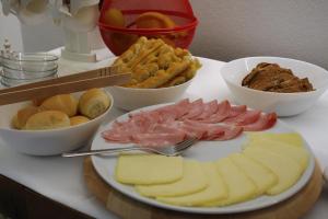 a table with a plate of cheese and other foods at ARIA Design B&B Levanto in Levanto