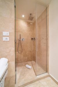 a bathroom with a shower with a glass door at Rooms Milano Duomo in Milan