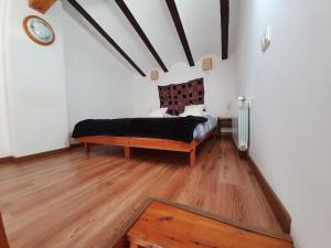 a bedroom with a bed and a wooden floor at Apartment Cal Viola in Torroja +81 photos
